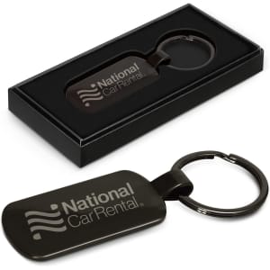 A black key ring in a sleek black box, featuring a logo on the surface.