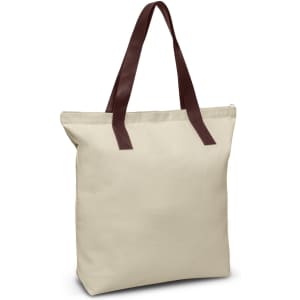 A cream tote bag with brown leather handles. The bag has a simple design and without any logos.