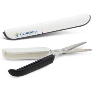 Compact scissors with a white and black design, housed in a protective case. Includes a logo on the case.