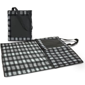 A black and grey checkered picnic blanket with a carrying handle and pocket, folded neatly beside an open version.
