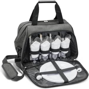 A grey picnic bag opened to reveal dinnerware, including forks, knives, plates, and glasses, neatly organised inside.