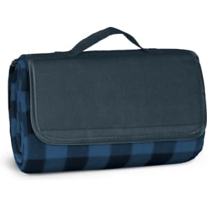 A folded picnic blanket in dark blue and navy check pattern, secured with a handle. It features a logo on the side.