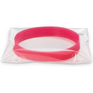 A pink silicone wristband in a clear packaging, designed to glow in the dark. It features a logo.