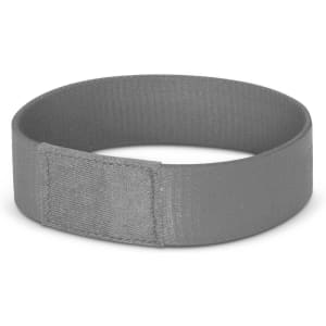 A grey wristband with a smooth finish and a fold-over design. It features a branding logo.