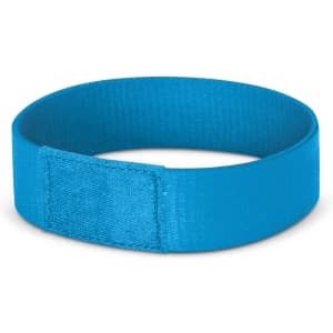 A blue wristband with a smooth finish and a branding logo, designed for events and exhibitions.