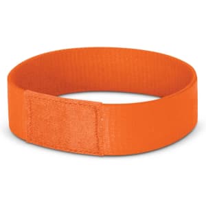 An orange wristband designed for events, featuring a secure fastening mechanism.
