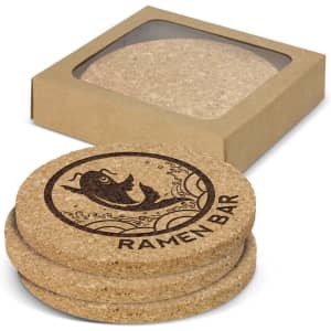 A set of four round cork coasters in natural colour, packaged in a brown box, featuring a fish design.