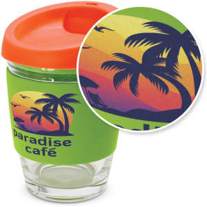 A drink bottle featuring a clear glass body, orange lid, and green silicone sleeve with a tropical palm design.