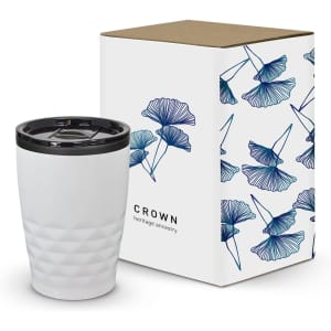 A white coffee cup with a patterned surface, accompanied by a decorative box featuring floral designs.