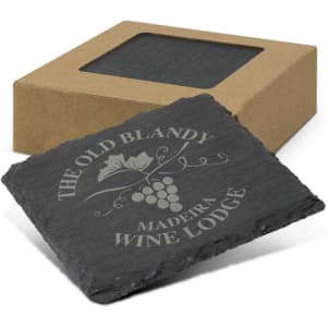 A set of four grey slate coasters, packaged in a brown box with a clear window, featuring a logo engravement.