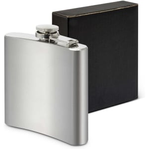 A silver hip flask with a screw top, displayed alongside a black box. It features a logo on the flask.
