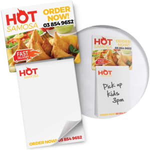 A magnetic memo pad in full colour featuring a logo, with a notepad and a sticky note showing handwritten text.