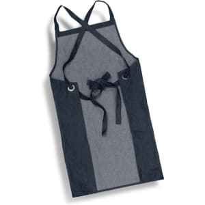 A denim bib apron featuring shades of dark blue and grey, with a waist tie and crossed back straps.