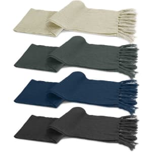 A collection of Nebraska Cable Knit Scarves in cream, dark green, teal, and charcoal, featuring fringed edges.