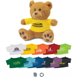 A plush teddy bear in a yellow shirt sits surrounded by miniature shirts in various colours. The bear has a logo on its shirt.