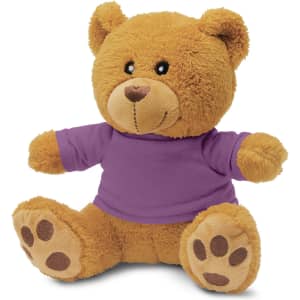 A plush teddy bear toy, featuring a soft, tan body and a purple shirt, with rounded ears and paw prints on its feet.