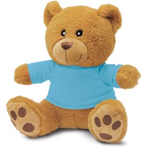 A fluffy tan teddy bear plush toy wearing a blue shirt, featuring a friendly face and paw prints on its feet.