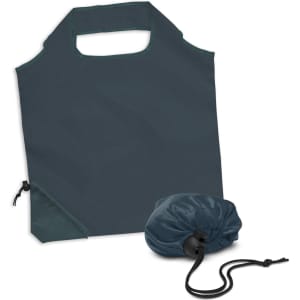 A foldable reusable grocery bag in dark green, stored compactly in a matching pouch. Features a handle and drawstring closure.