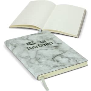 A marble-patterned soft cover notebook with lined pages and a ribbon bookmark. Features a logo on the front.