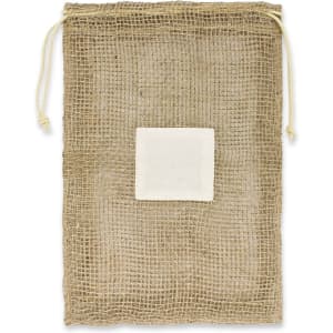 A jute net produce bag with a drawstring closure and a white label patch in the center.