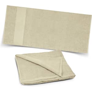 A sandy beige Dune Beach Towel, featuring a soft, textured surface and a plain section with branding.