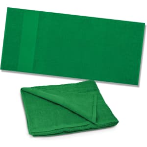 A green Dune Beach Towel displayed flat and folded, highlighting its soft texture and vibrant color.
