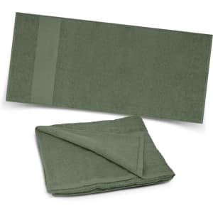 A green Dune Beach Towel displayed unfolded and folded, highlighting its soft texture and simple design.