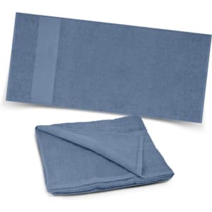 A blue beach towel is displayed, featuring a textured surface and a smooth panel. It folds neatly for storage.