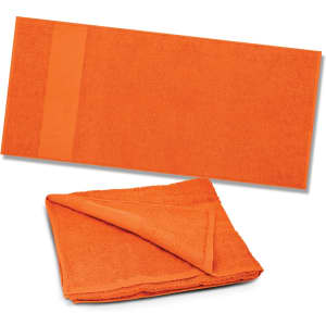 An orange beach towel featuring a textured surface and a woven band along one edge.