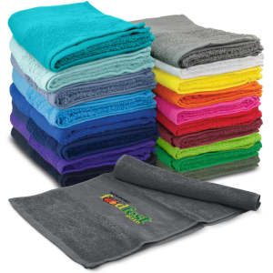 A stack of colourful gym towels in various shades including teal, grey, purple, yellow, and pink, with one grey towel displayed prominently.