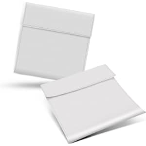 A set of two white reusable food pouches with a simple fold-over closure, designed for carrying food items.