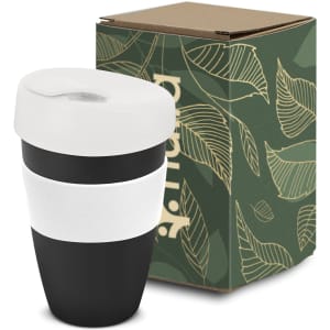 A drink bottle in black and white, featuring a lid and a white band, accompanied by a green boxed packaging with leaf design.