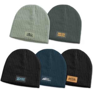 A collection of Nebraska cable knit beanies in various colours, featuring different patches and logos.