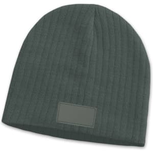 A green cable knit beanie with a patch, featuring a textured design.