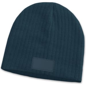 A teal cable knit beanie featuring a patch, displaying a textured design.