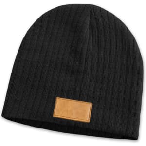 A dark grey cable knit beanie featuring a patch on the front. The beanie has a ribbed texture.