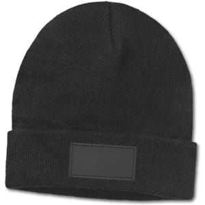 A black beanie featuring a blank patch for customization. The beanie has a cuffed design and a textured knit.