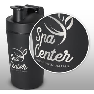 A black protein shaker with a secure lid, featuring a logo on the side and a sleek, matte finish.