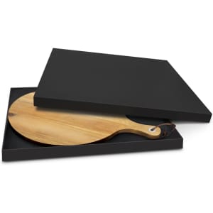 A wooden serving board with a handle, presented in a sleek black box, ready for gifting or display.