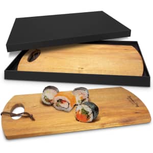 A wooden serving board in a black box, featuring a unique shape and sushi displayed on top.