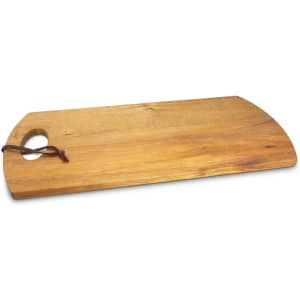 A wooden serving board with a curved edge and a handle, featuring a natural finish and a leather strap.