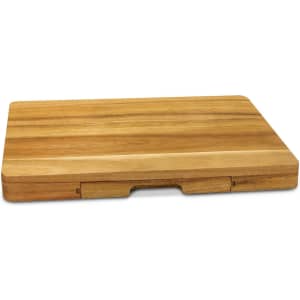 A wooden cheese board in shades of light and dark brown, featuring a sliding compartment for knives.