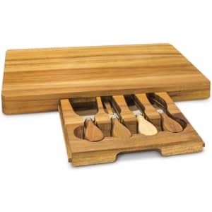 A wooden cheese board with a pull-out drawer containing four cheese knives. The board features a natural wood finish.