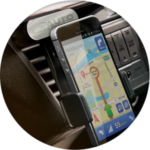 A car phone holder displaying a smartphone with a navigation app, secured in a black mounting clip. It has a branding logo.