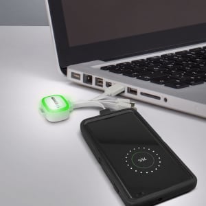 A white Zodiac Charging Cable connects to a laptop, with a smartphone displaying a charging indicator.