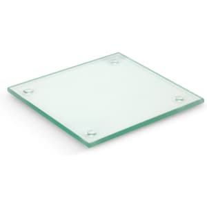 A square glass coaster with a subtle green tint and rubber feet on each corner for stability.