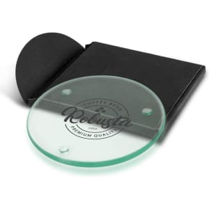 A round glass coaster in green, packaged with a black folder, featuring a logo design.