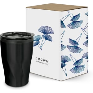 A black coffee cup next to a patterned box featuring blue floral designs and branding.