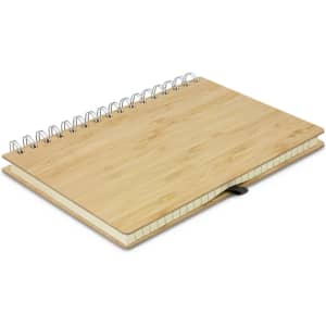 A bamboo notebook with a spiral binding and a leather strap, featuring a natural wooden finish.
