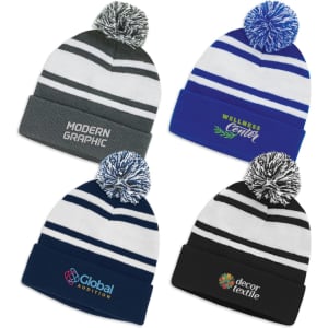 A collection of four beanies with pom poms, featuring different colour schemes and logos.